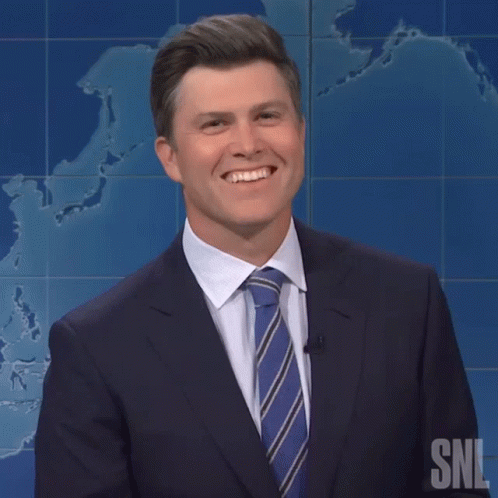 Smiling Colin Jost GIF
