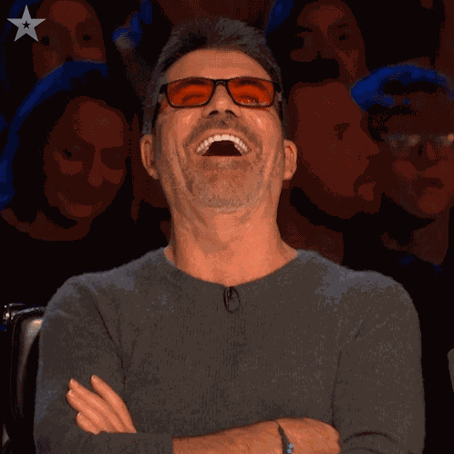 Laughing Simon Cowell GIF