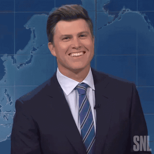 Smiling Colin Jost GIF