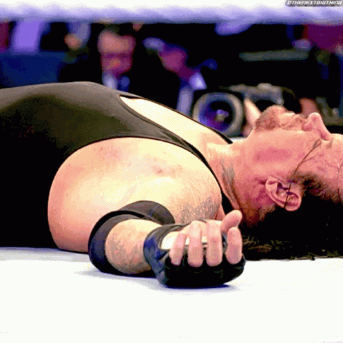 The Undertaker Laying Down GIF